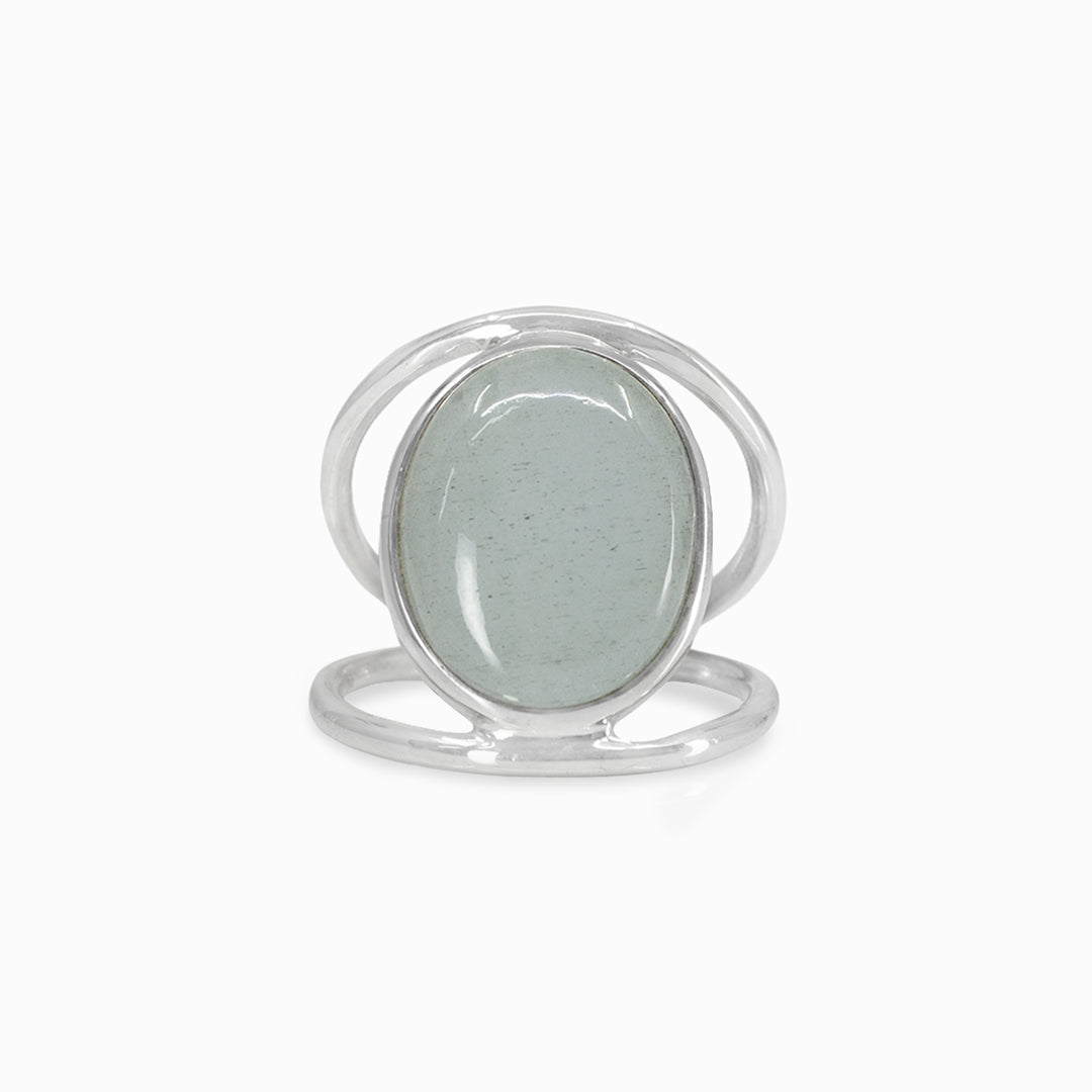 Silver ring with a light blue gemstone on a white background
