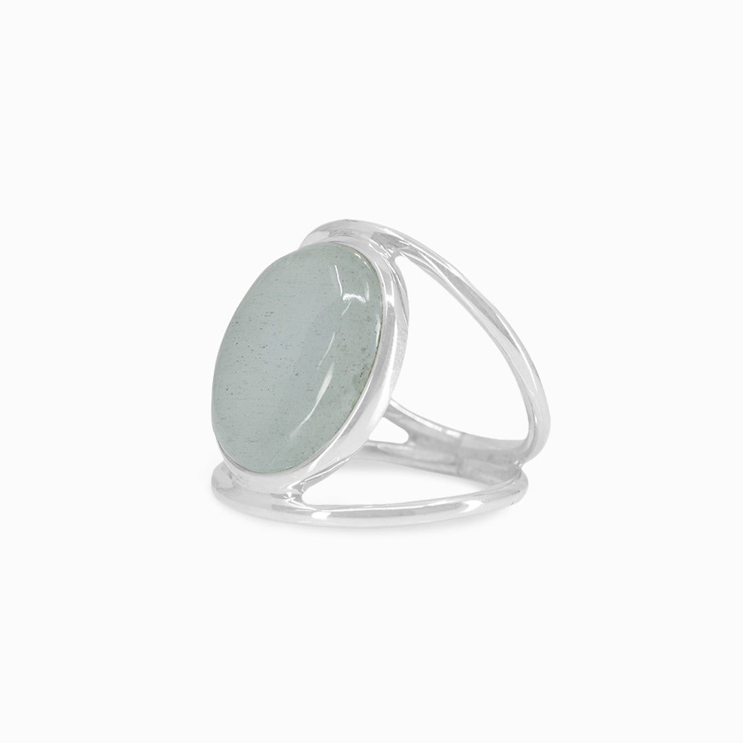 Silver ring with a light blue gemstone on a white background