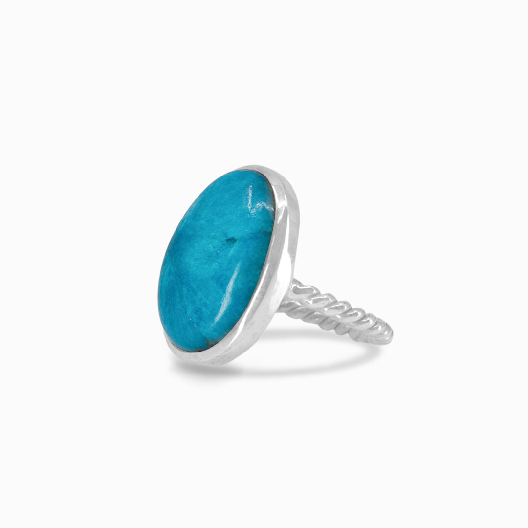 Silver ring with a blue gemstone on a white background
