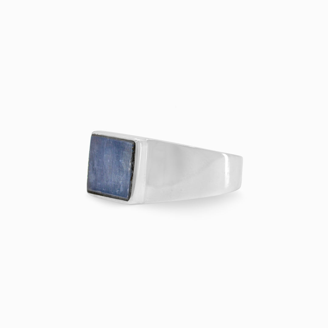 Silver ring with a blue gemstone on a white background