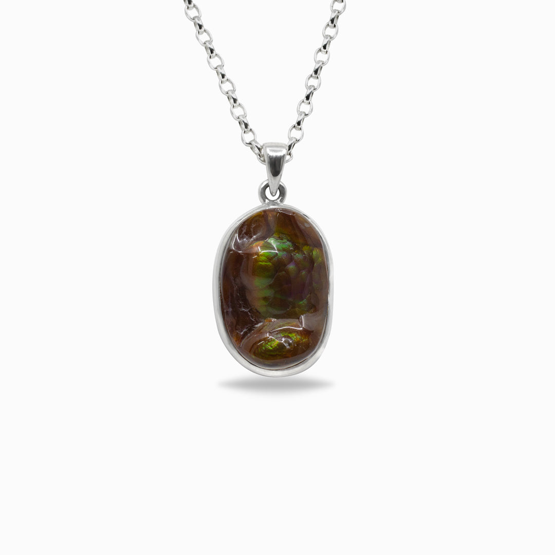 Silver pendant with a brown gemstone on a white background