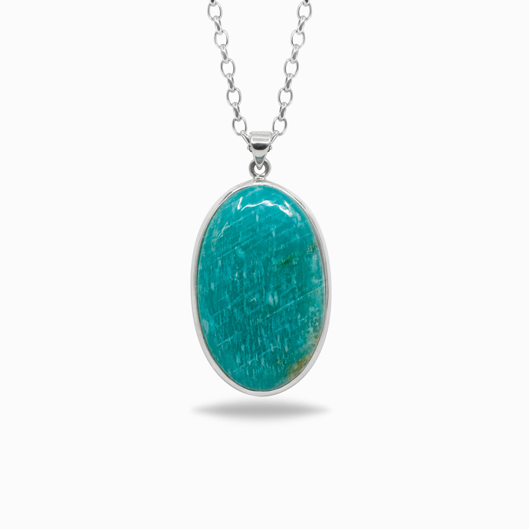 Silver necklace with a green gemstone on a white background