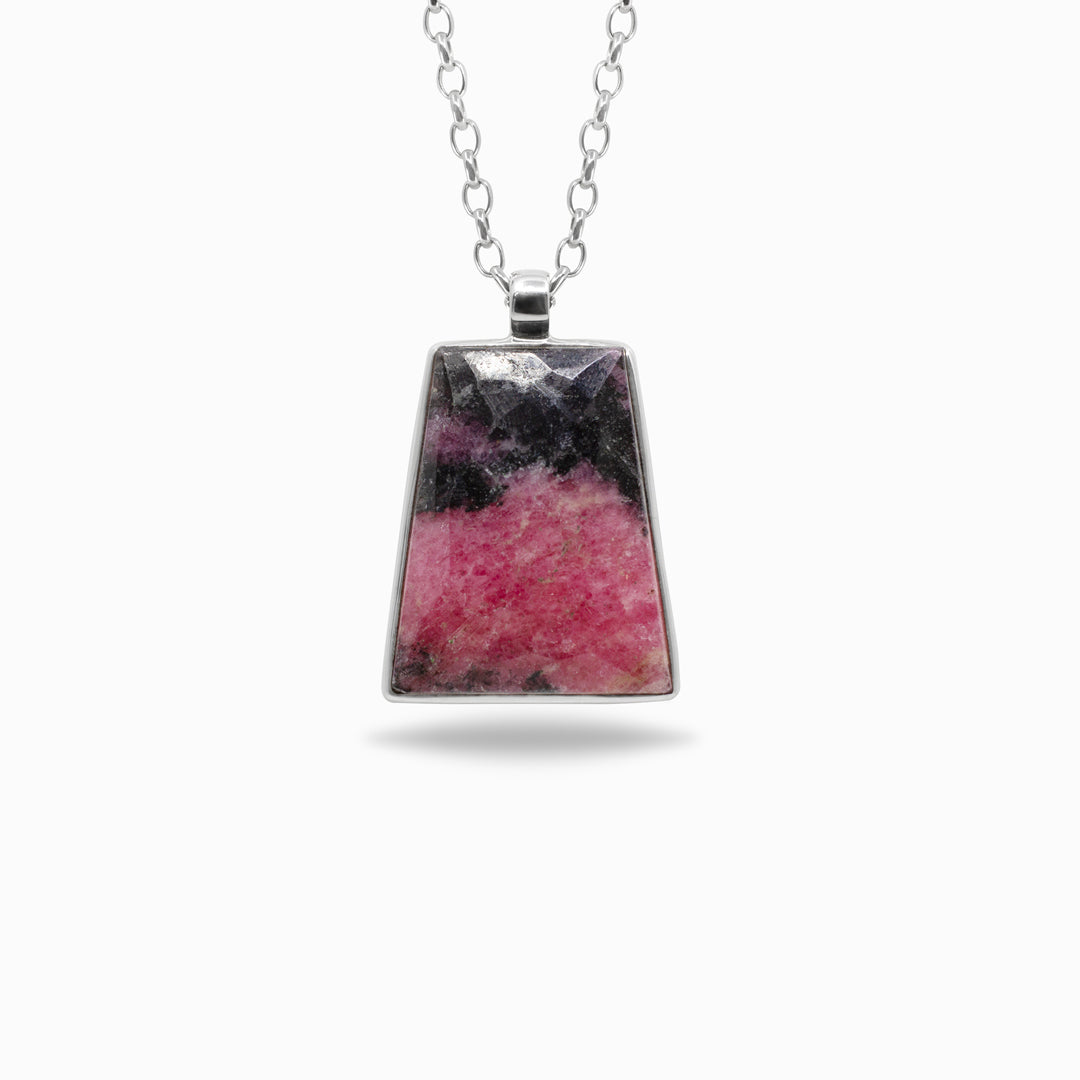 Necklace with a pendant featuring pink and black stone on a white background