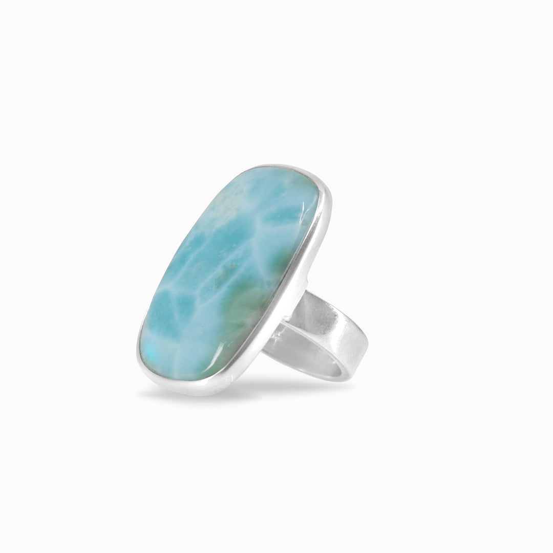 Silver ring with a light blue gemstone on a white background.