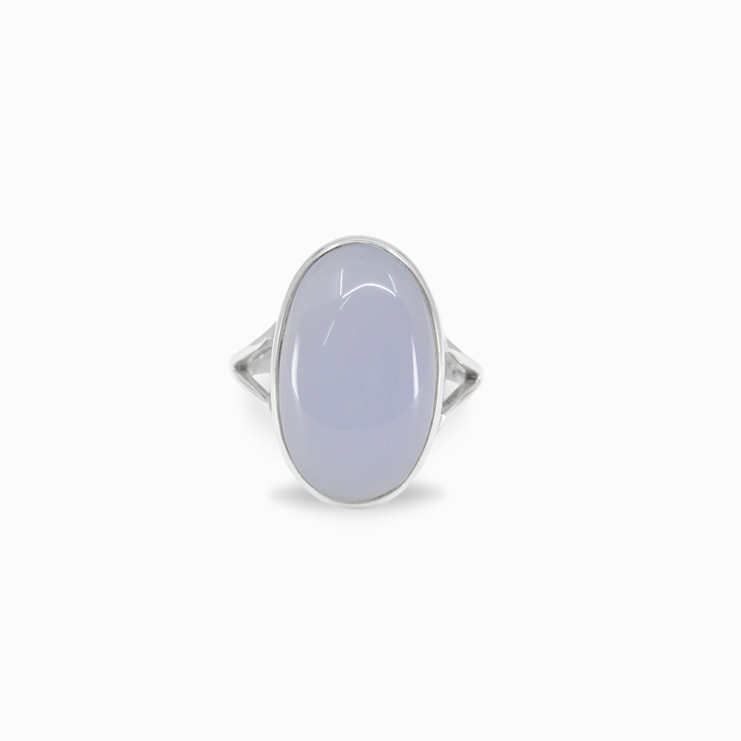 Silver ring with a light blue stone on a white background
