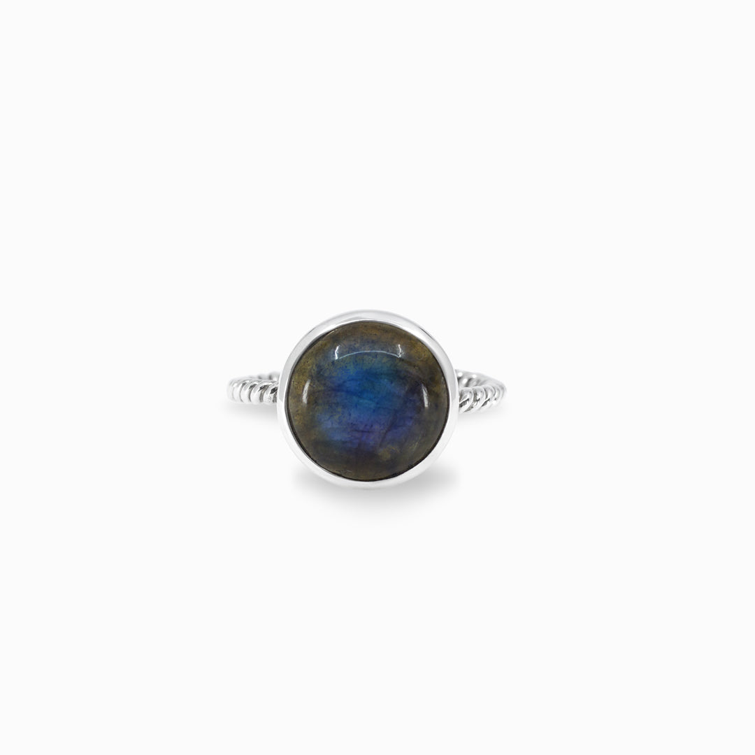 Silver ring with a blue gemstone on a white background