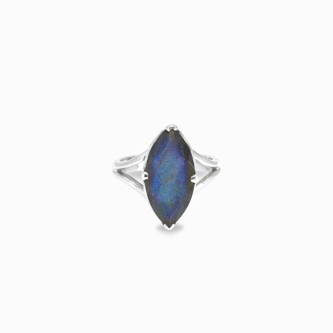 Silver ring with a marquise-shaped blue gemstone on a white background