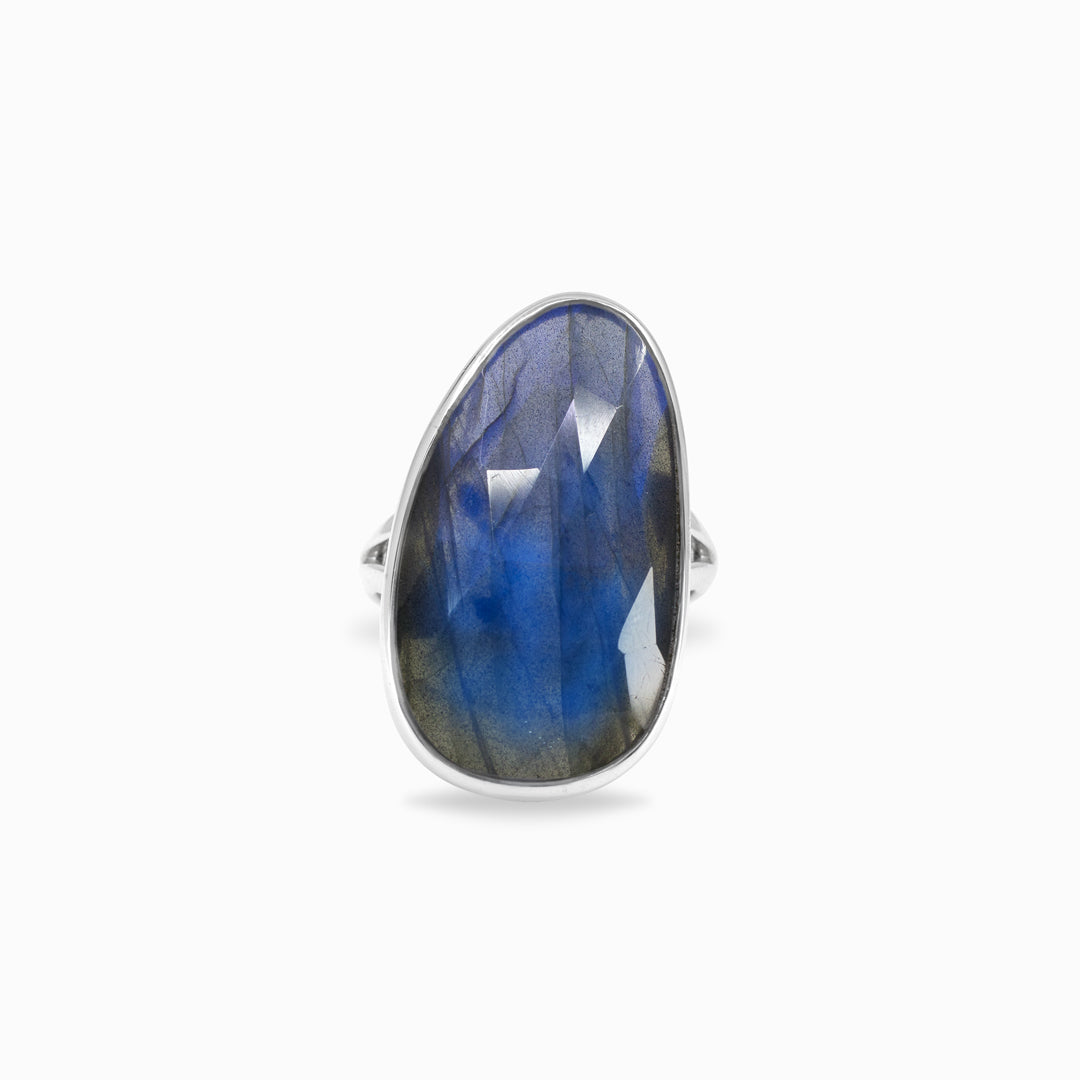 Silver ring with a blue gemstone on a white background