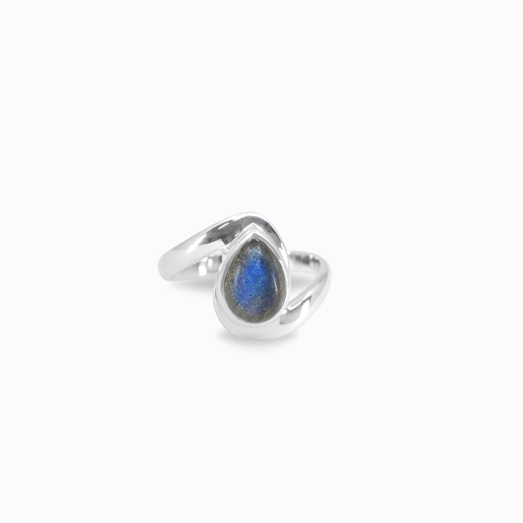 Silver ring with a blue gemstone on a white background