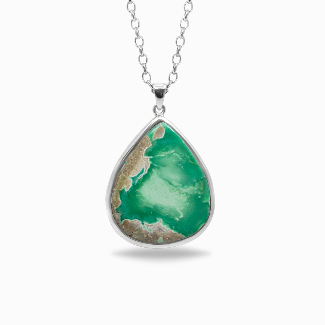 Teardrop-shaped green stone pendant on a silver chain against a white background