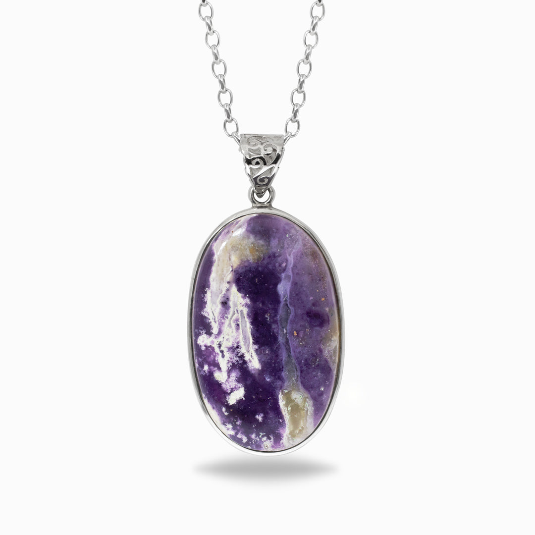 Silver necklace with a purple stone against a white background