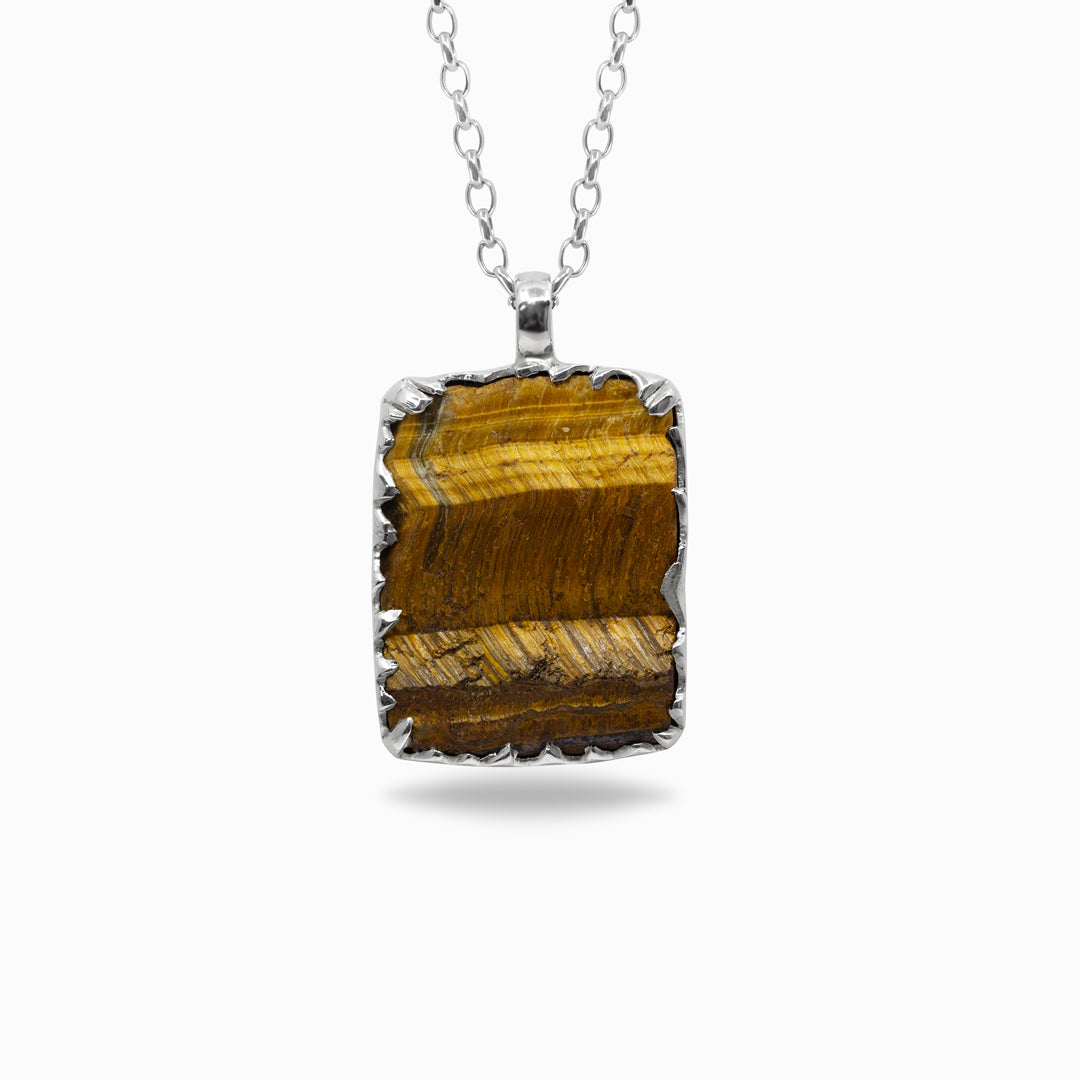Silver necklace with a brown stone pendant against a white background