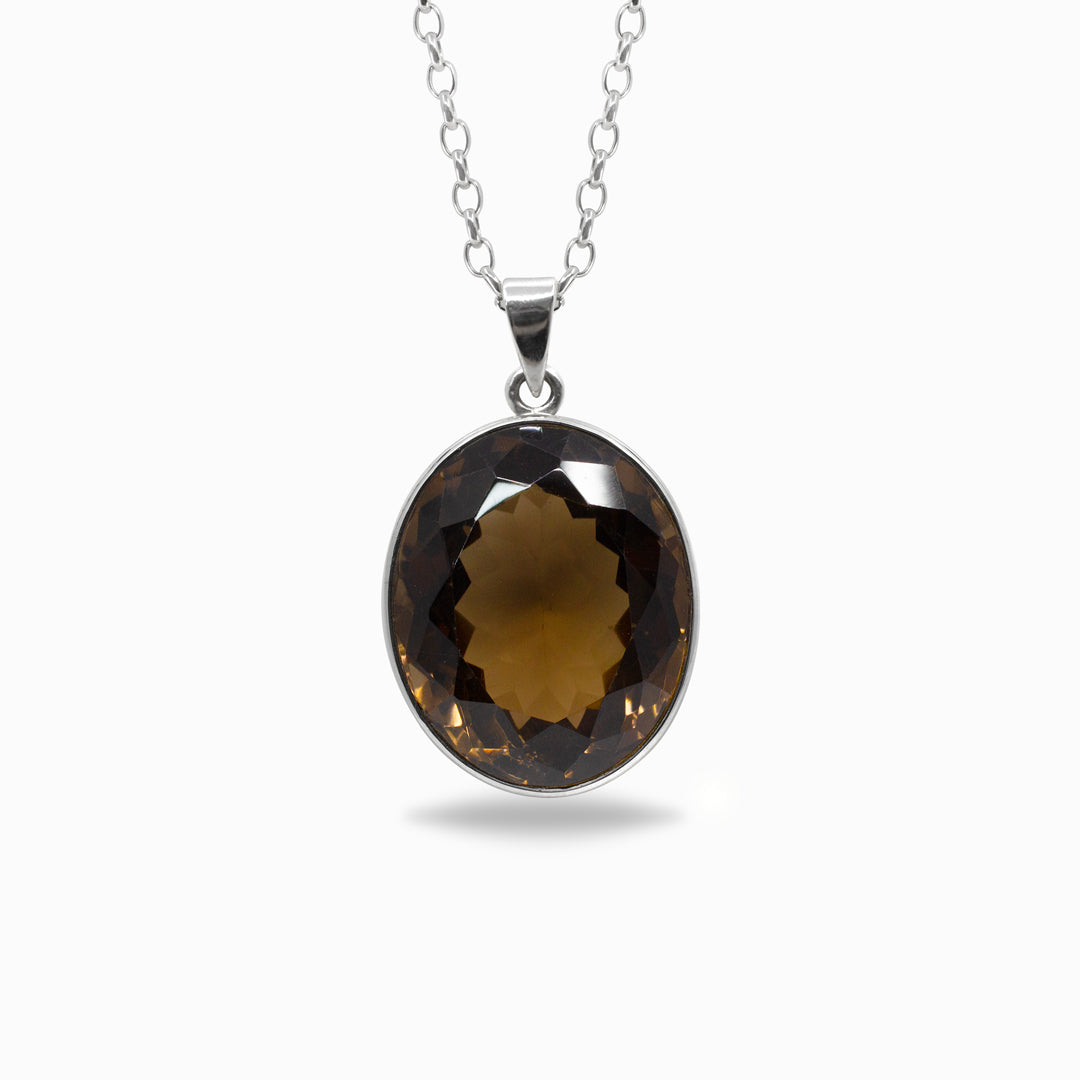 Smokey quartz pendant on a silver chain against a white background