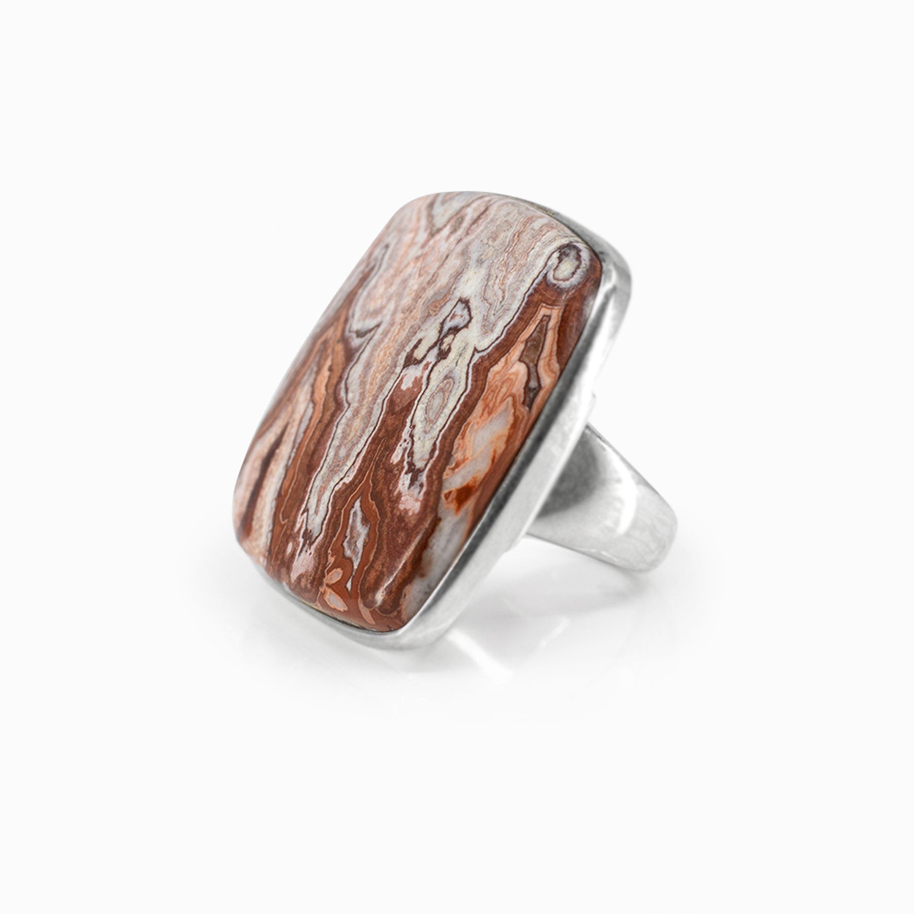 Silver ring with a square stone with brown and orange patterns on a white background