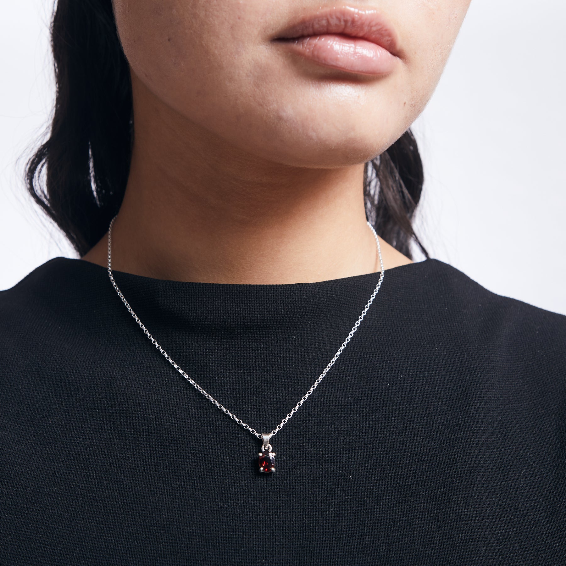 oval Garnet pendant with sterling silver chain on model