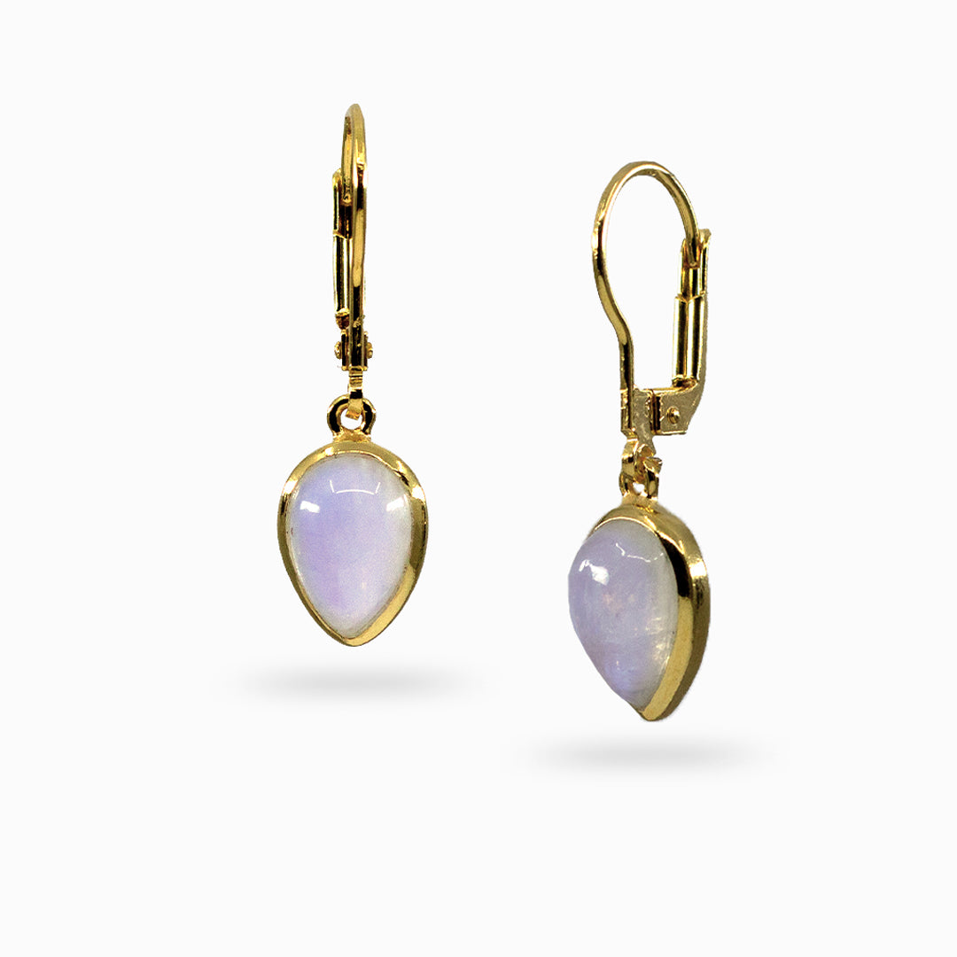 Golden earrings with inverted teardrop-shaped white stones on a white background