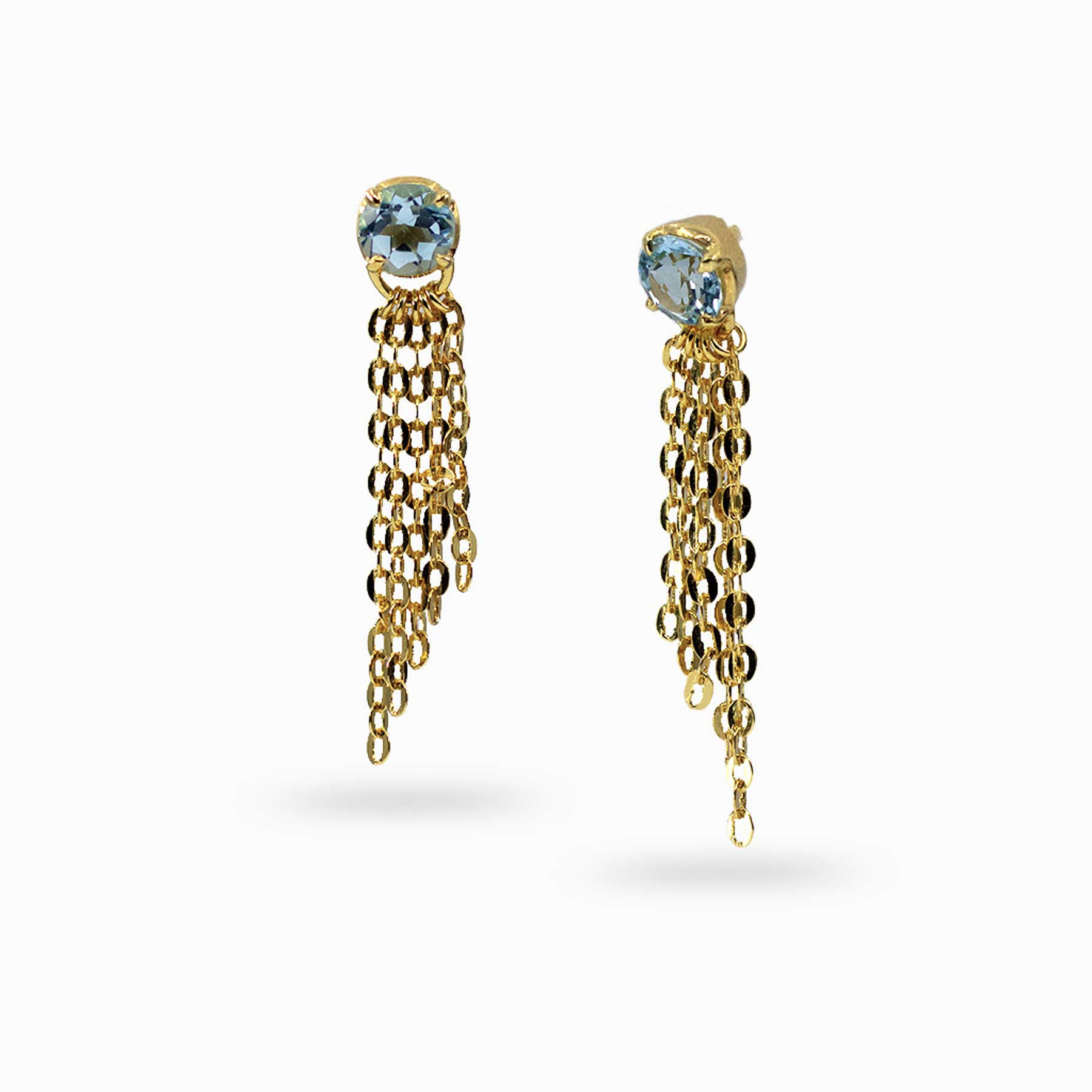 Golden earrings with blue gemstones and chain drops on a white background