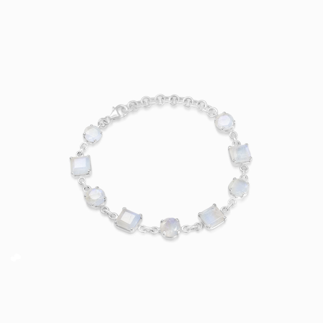 Silver bracelet with round and square-shaped gemstones on a white background