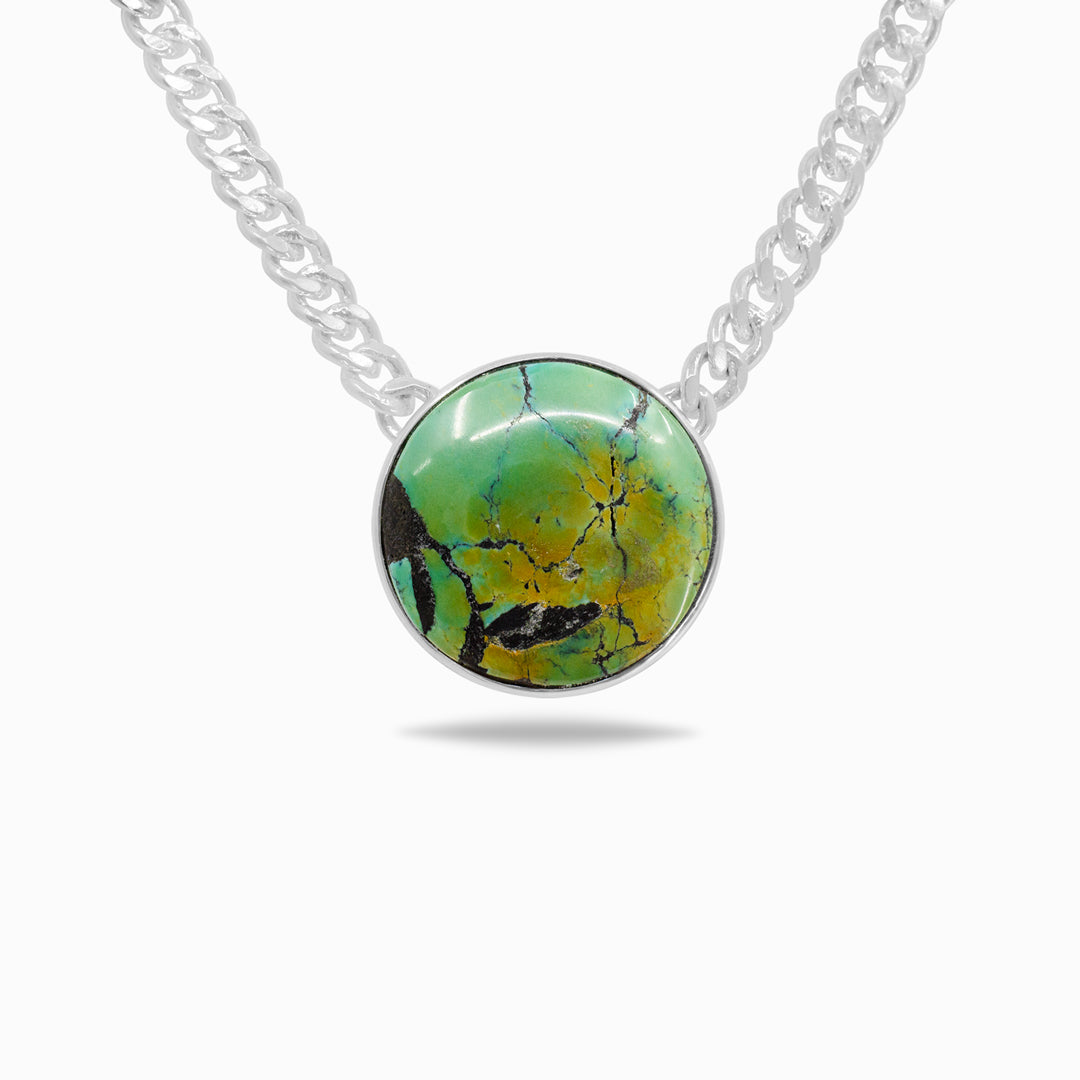 Silver necklace with a green and blue stone on a white background