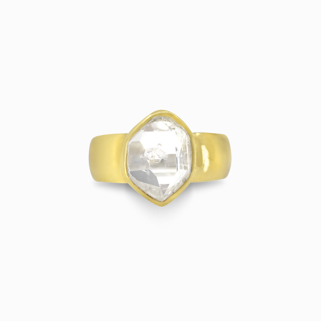 Gold ring with a clear stone on a white background