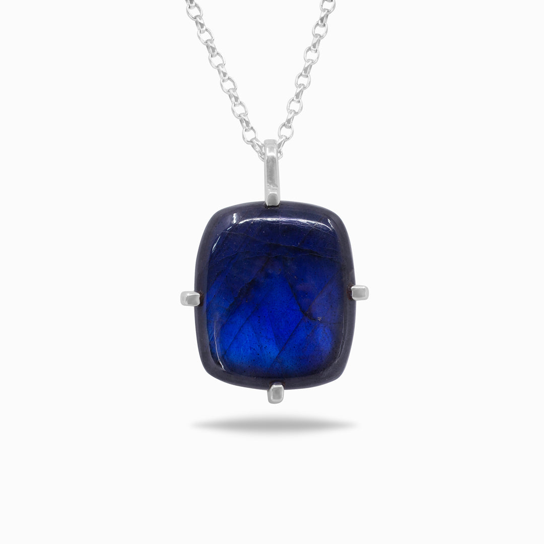 Silver necklace with a blue gemstone on a white background