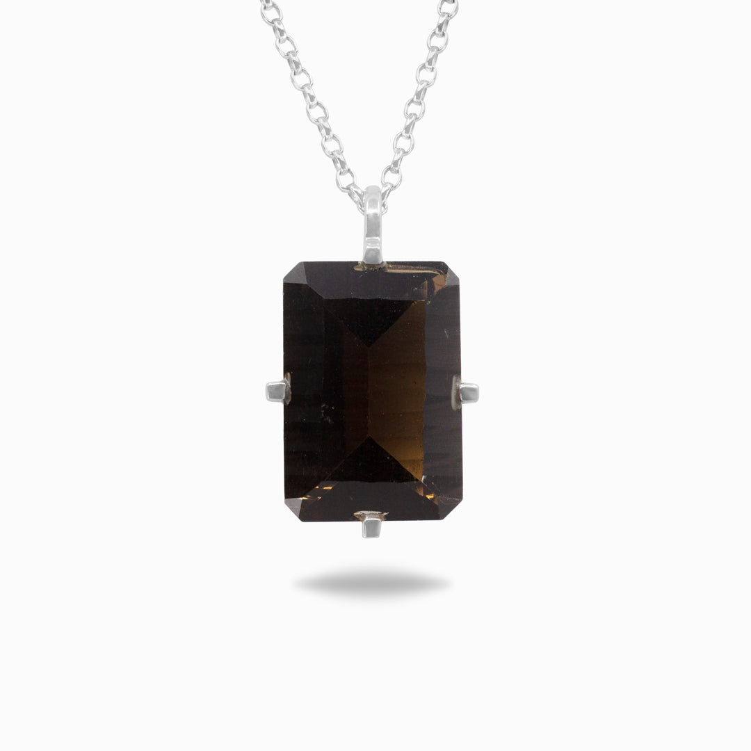Silver necklace with a rectangular smoky gemstone on a white background
