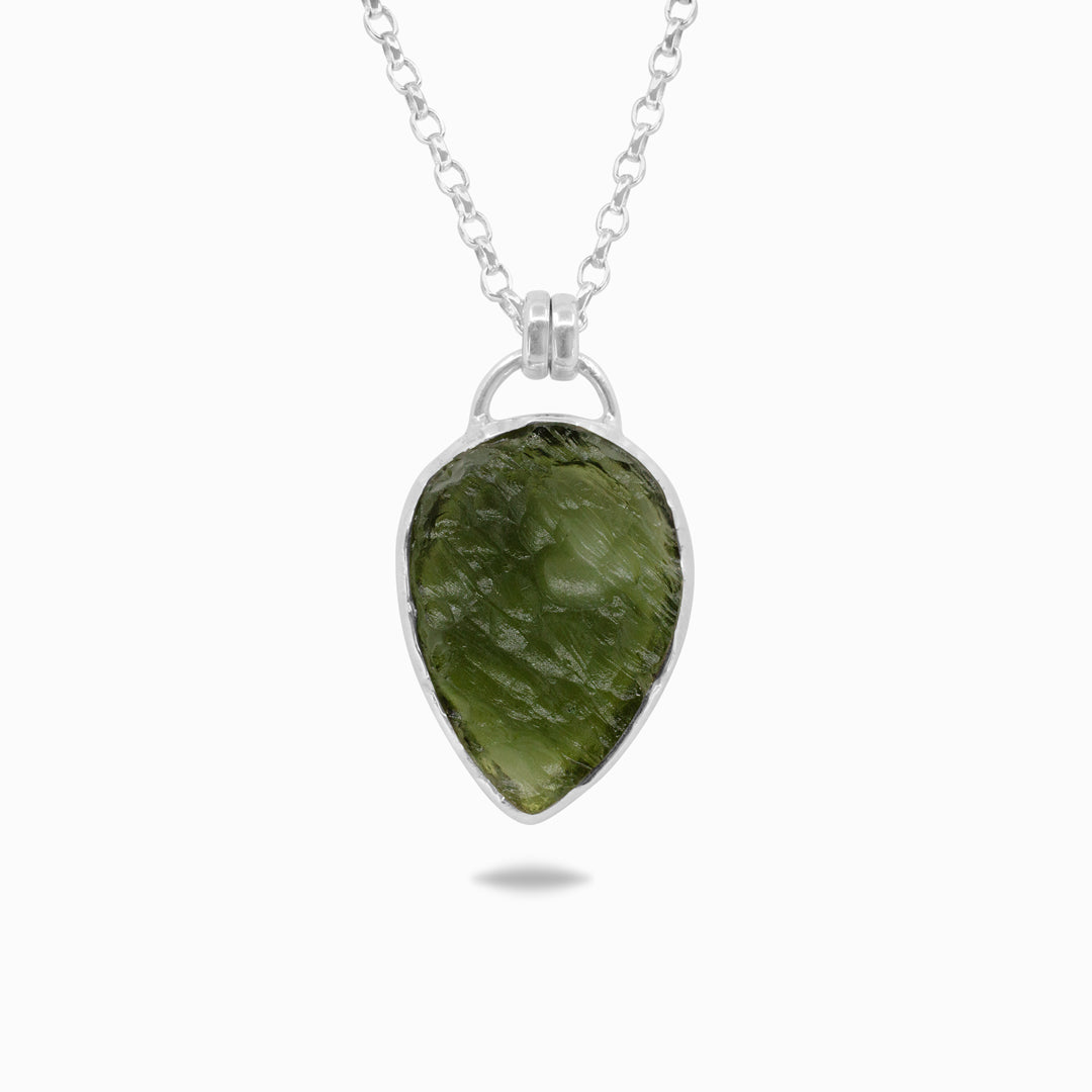 Silver necklace with a green gemstone on a white background