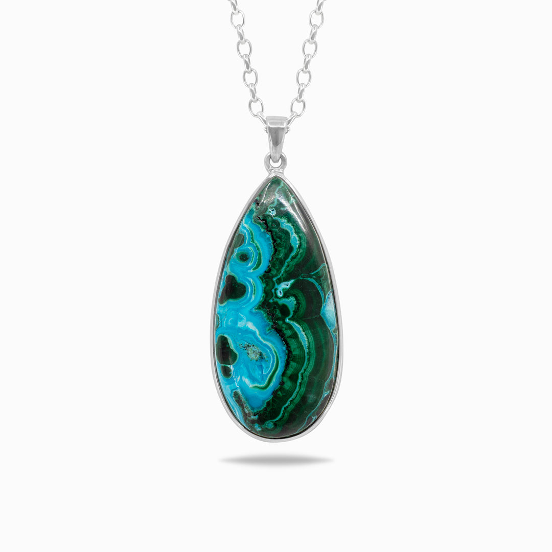 Silver necklace with a teardrop-shaped gemstone with blue and green marbled pattern on a white background