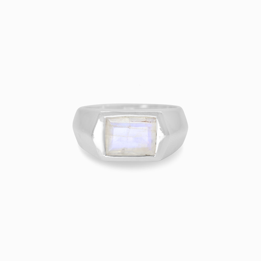 Silver ring with a rectangular gemstone on a white background