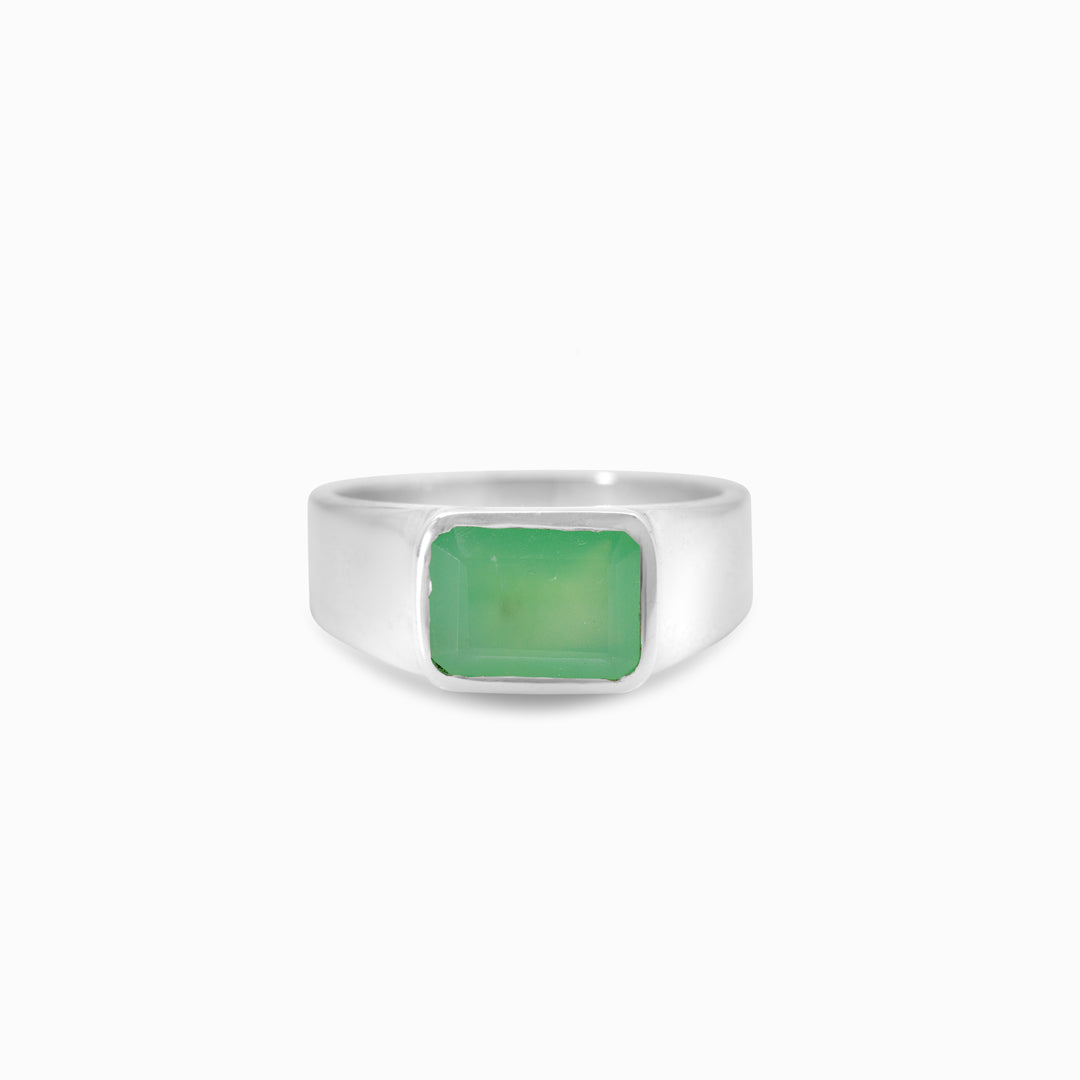 Silver ring with a green gemstone on a white background