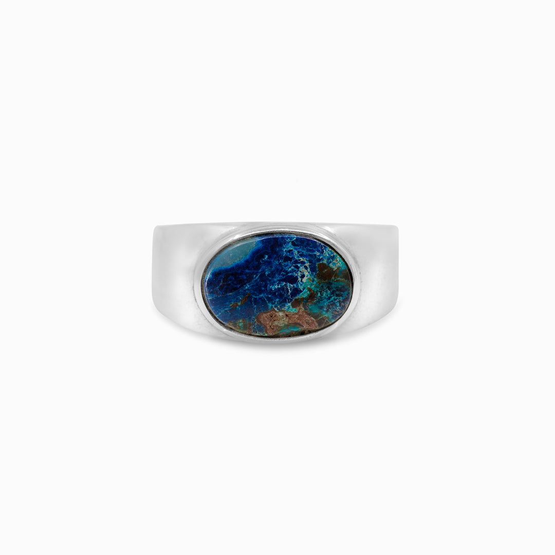 Silver ring with a green and blue gemstone on a white background