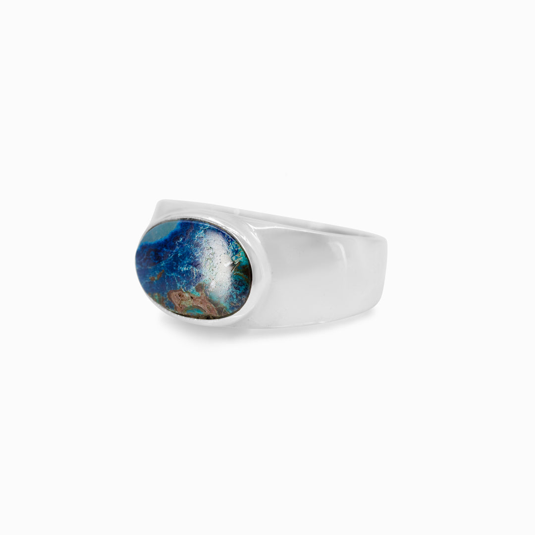 Silver ring with a green and blue gemstone on a white background
