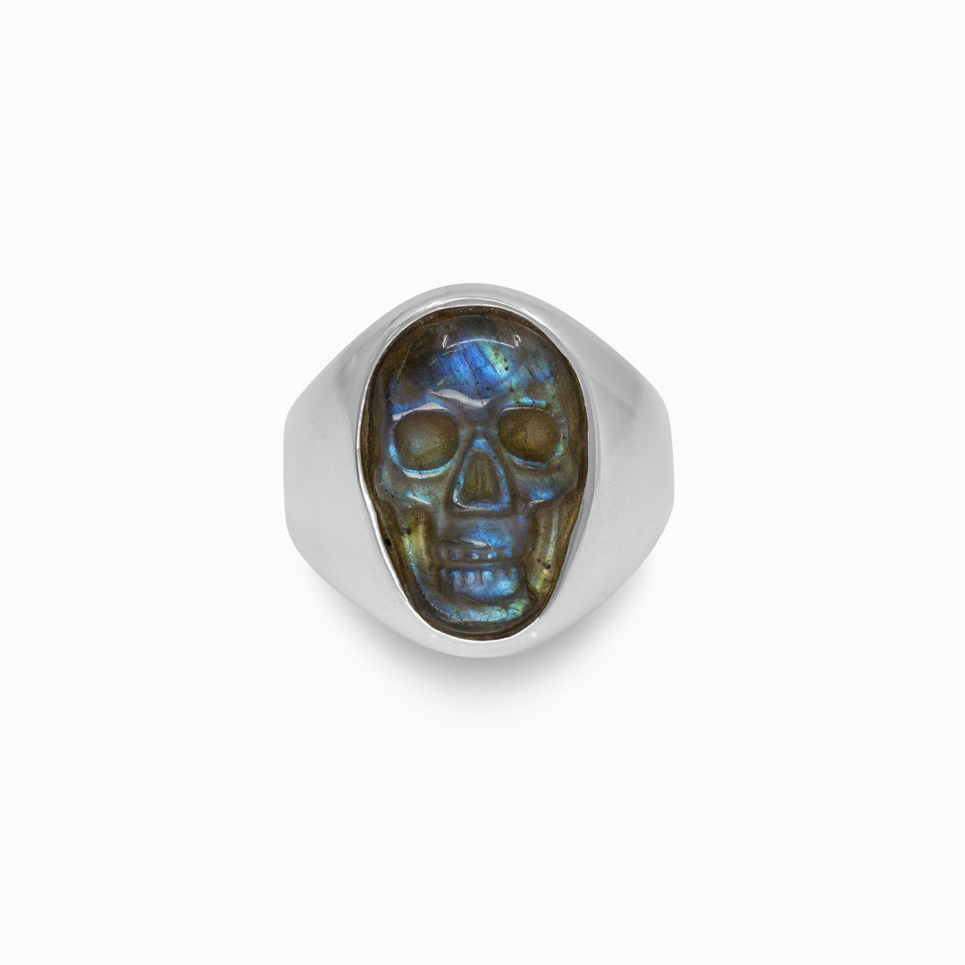Silver ring with a skull design on a white background