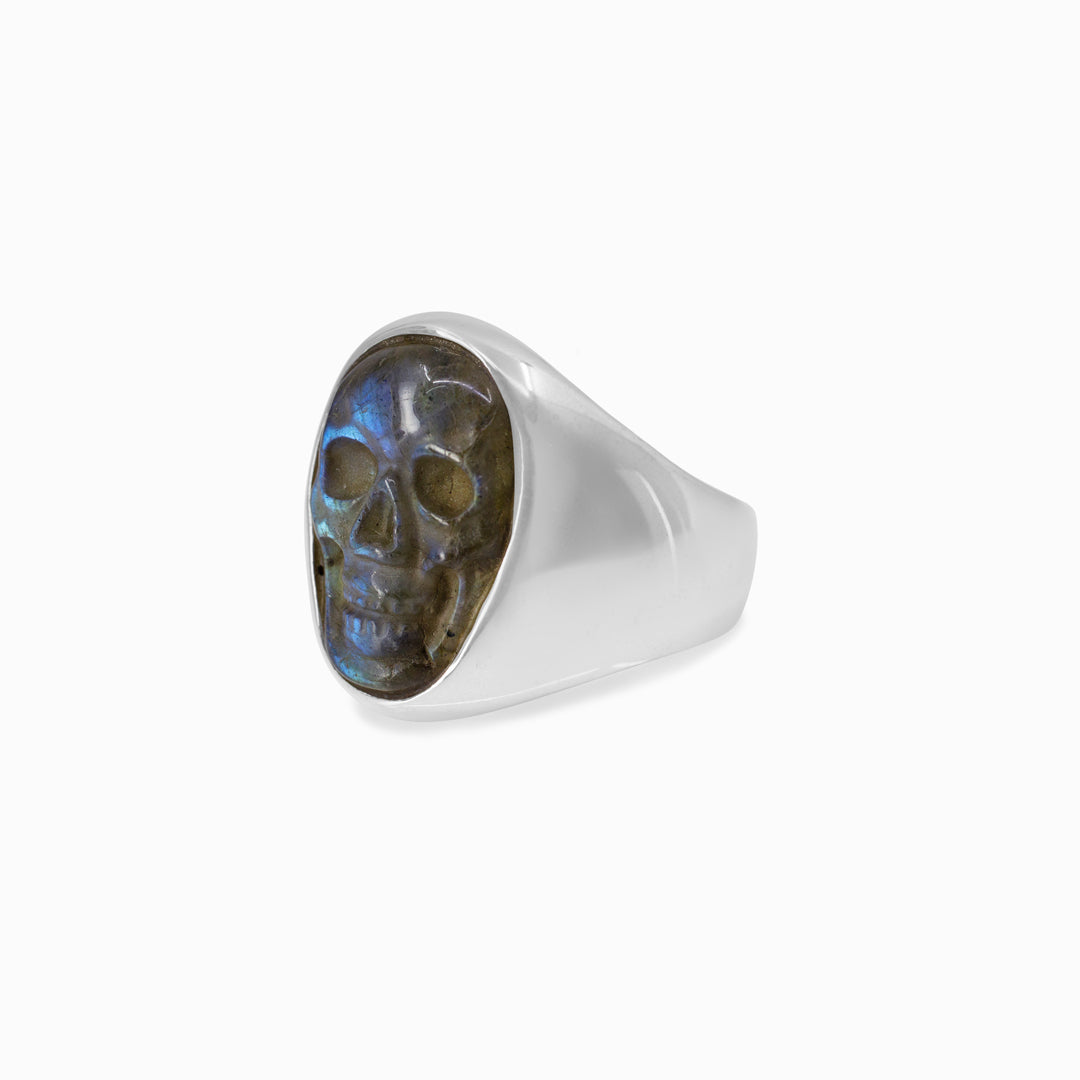 Silver ring with a skull design on a white background