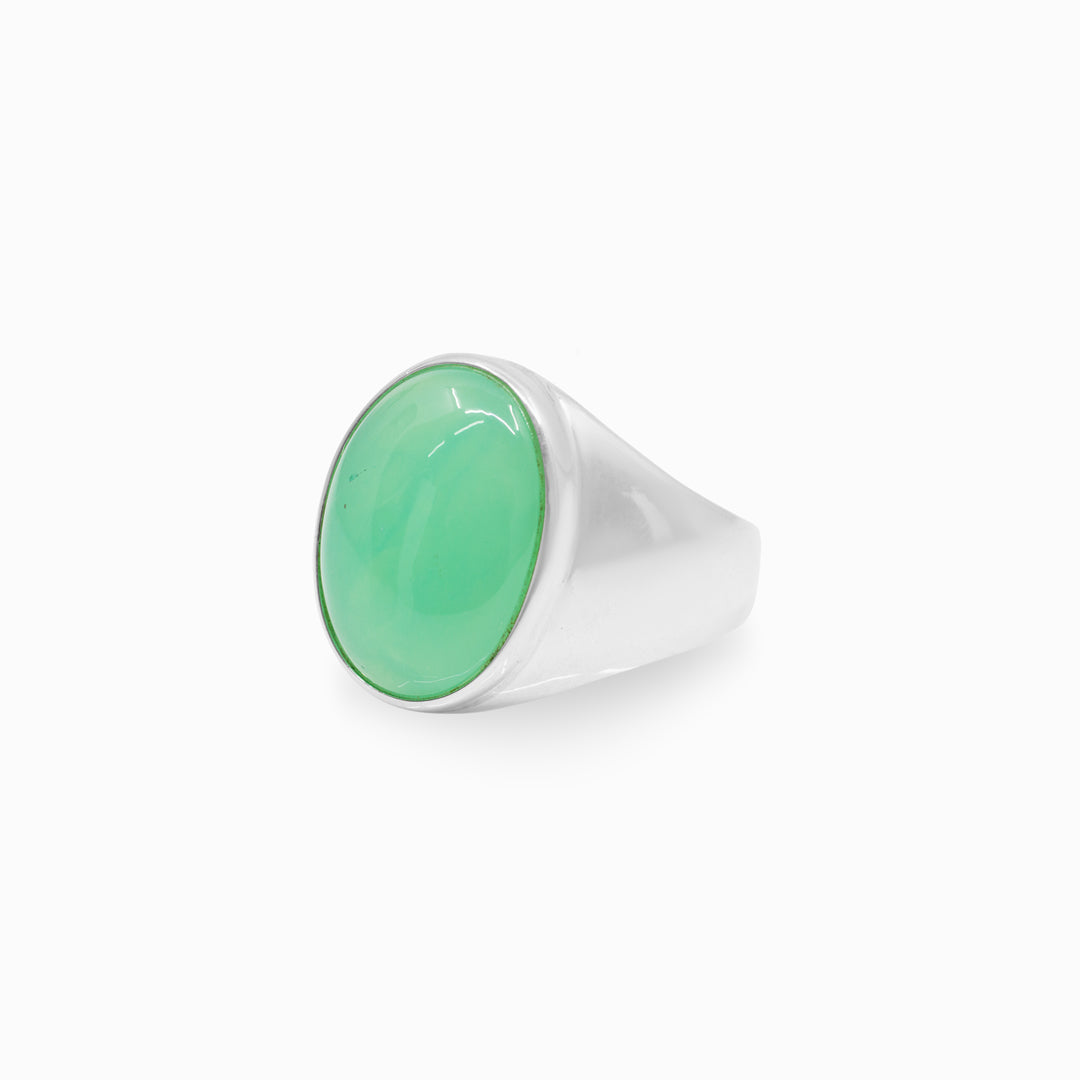 Silver ring with a green gemstone on a white background