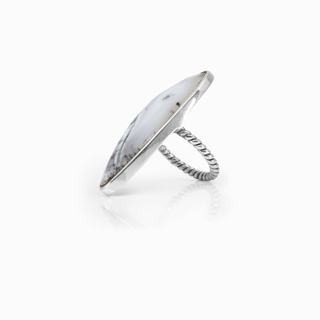 Silver ring with a white clear stone on a white background.