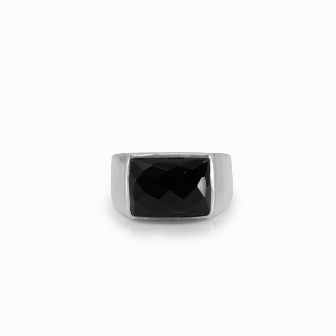 Silver ring with a black gemstone on a white background