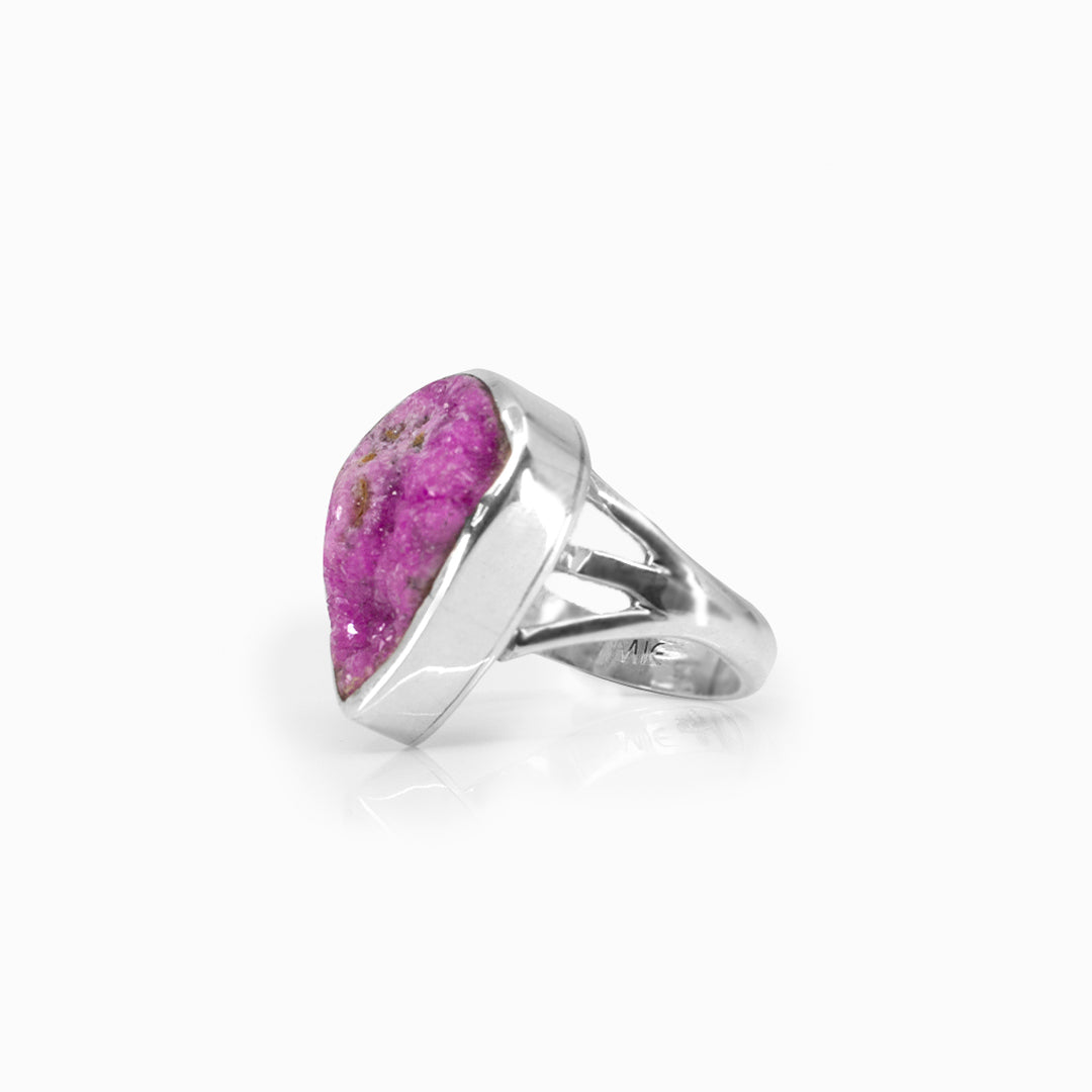 Silver ring with a pink gemstone on a white background
