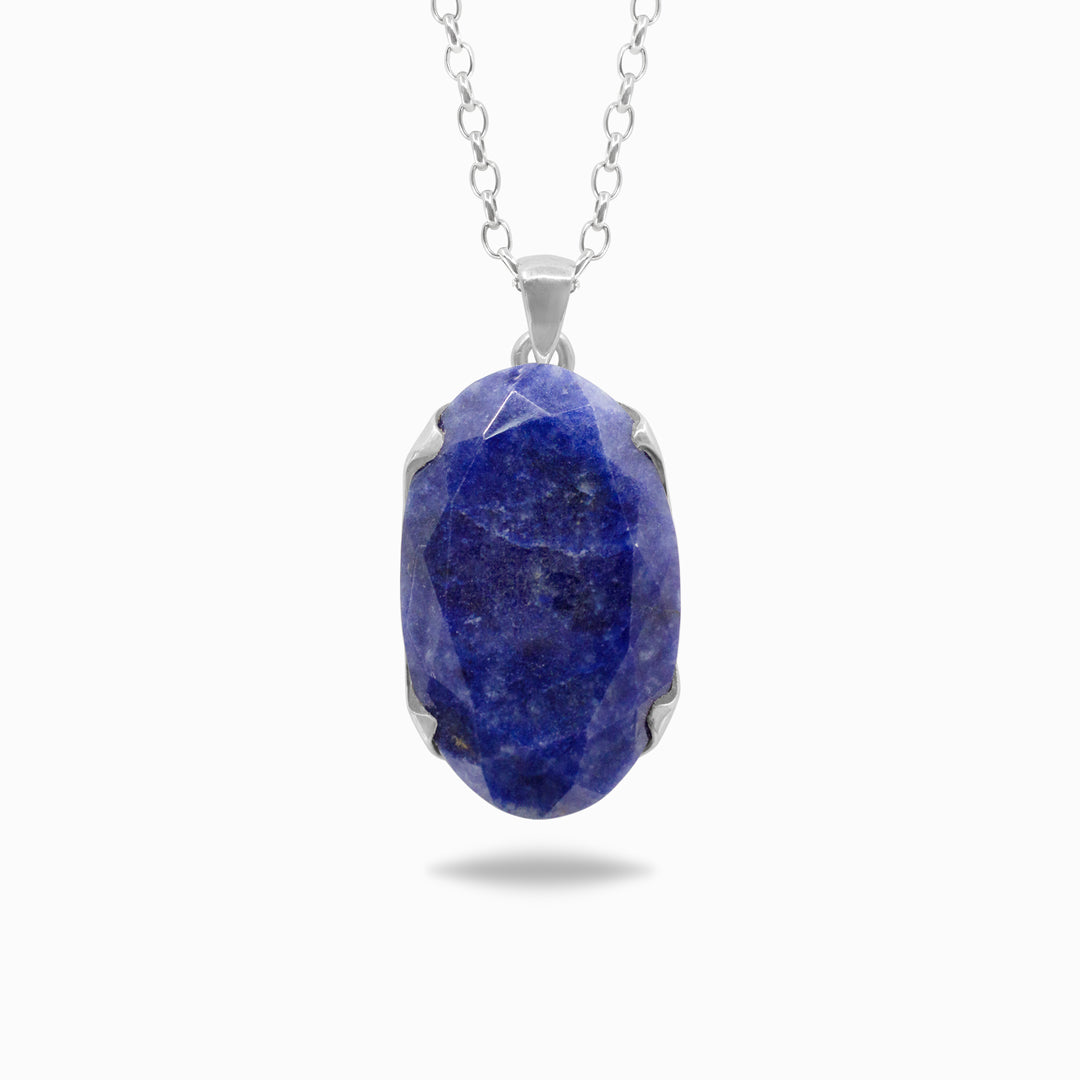 Silver necklace with a dark blue gemstone on a white background