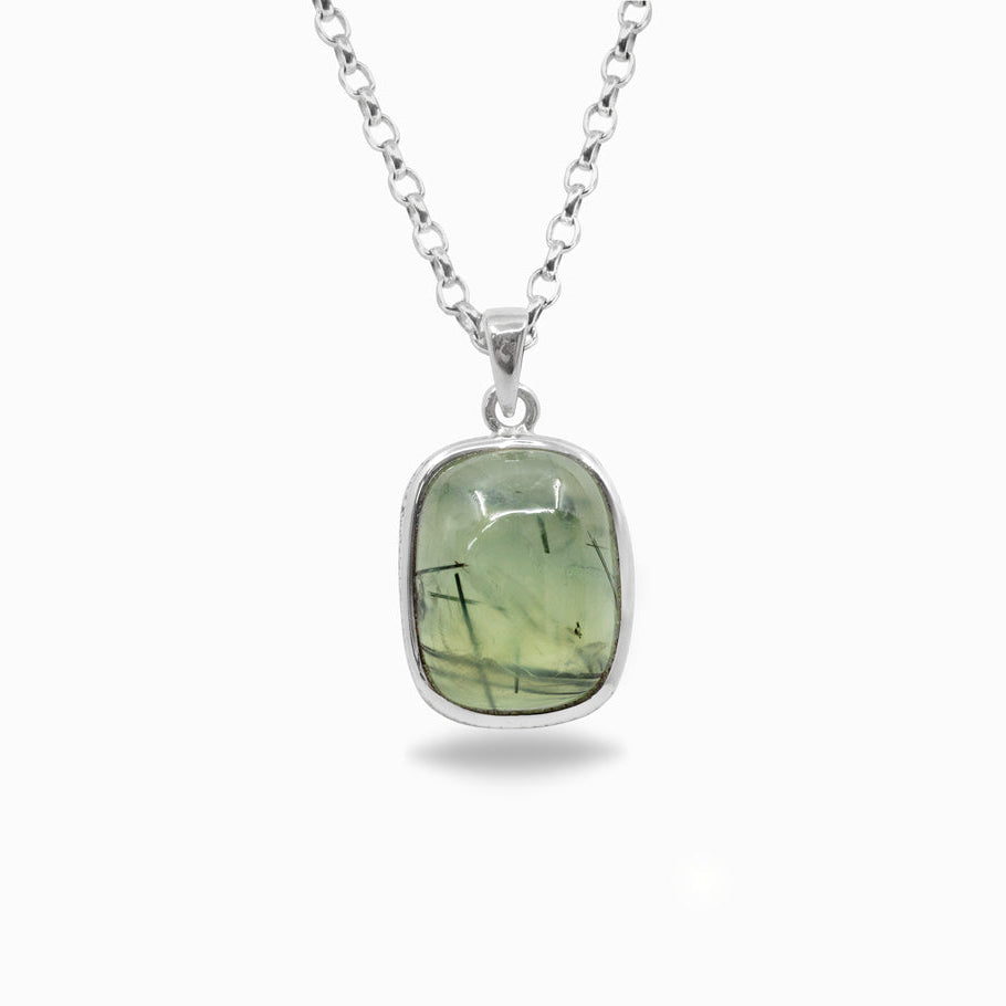 Silver necklace with a green stone pendant on a white background