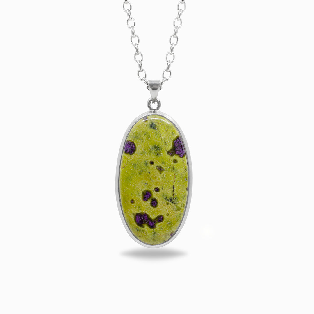 Necklace with an oval shape featuring a green stone with purple inclusions on a white background