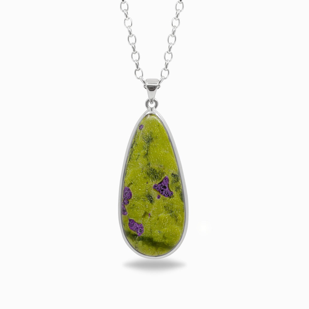 Silver teardrop-shaped pendant with green and purple patterns on a white background