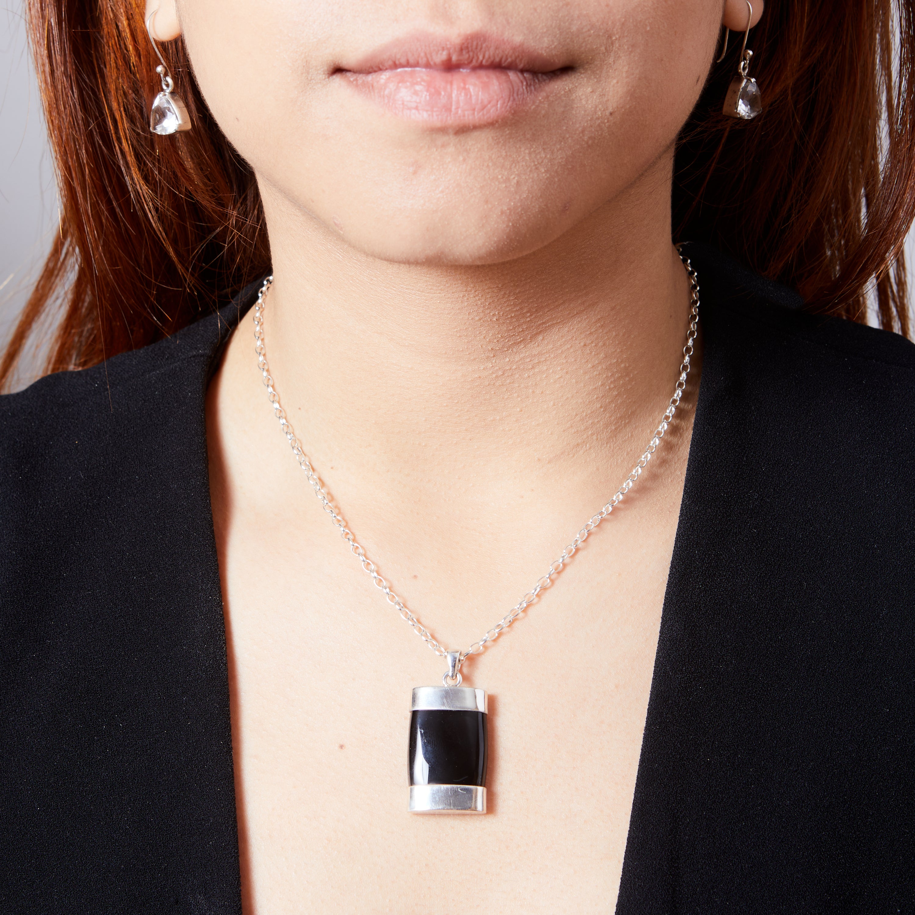 Black Onyx cabachon rectangle pencil with top and bottom cap pendant on model