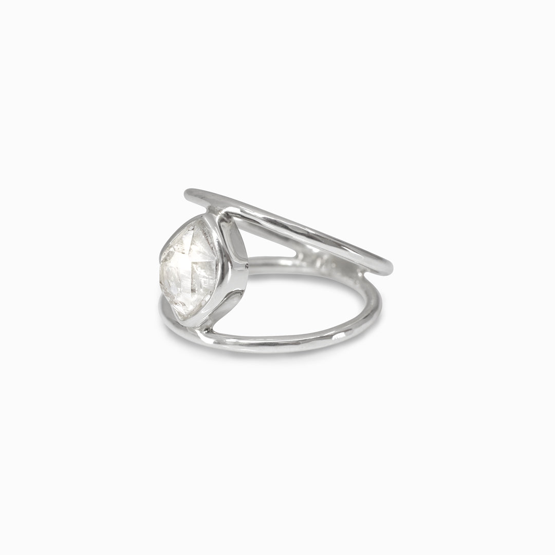 Silver ring with a freeform clear gemstone on a white background
