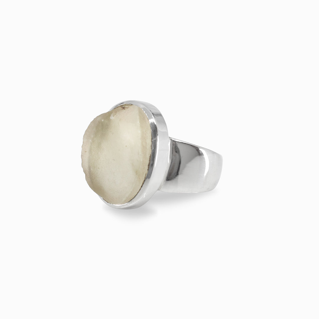 Silver ring with a light-colored stone on a white background