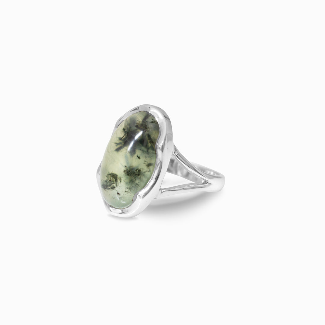 Silver ring with a green stone on a white background