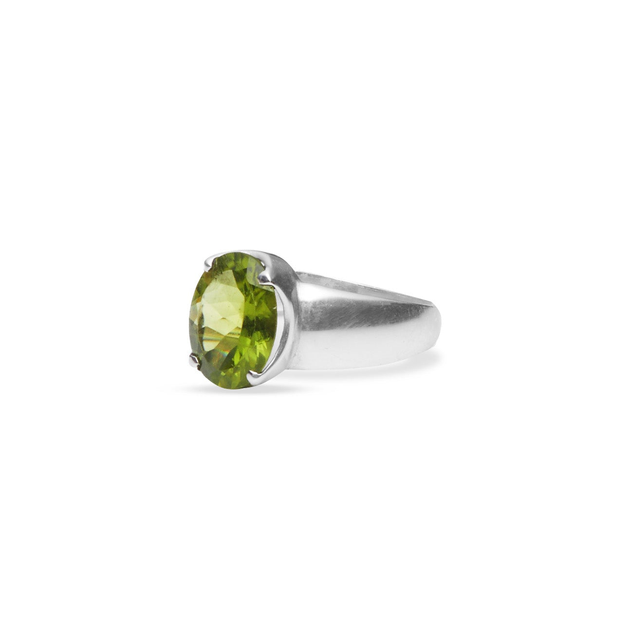 Peridot oval faceted ring with claw setting and thick a-line band side angle
