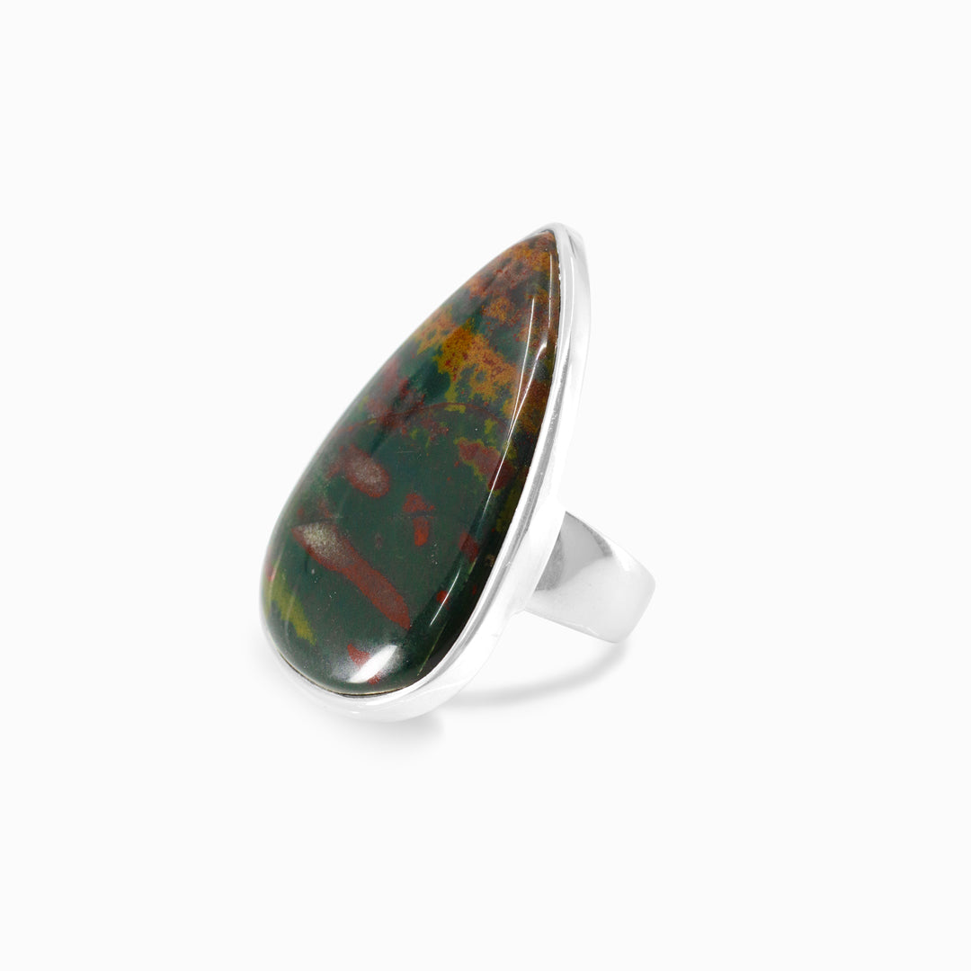 Silver ring with a teardrop-shaped gemstone on a white background