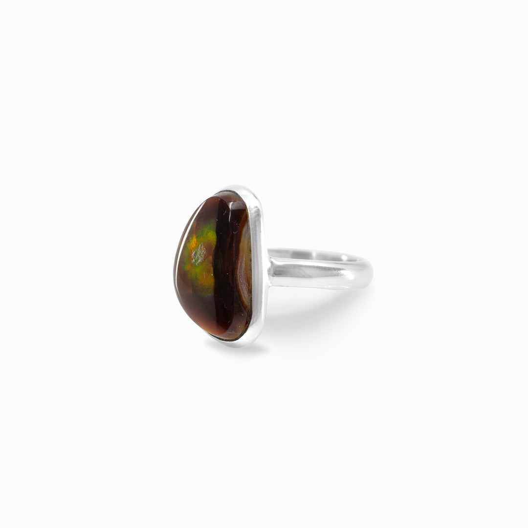 Silver ring with a brown and green freeform stone on a white background
