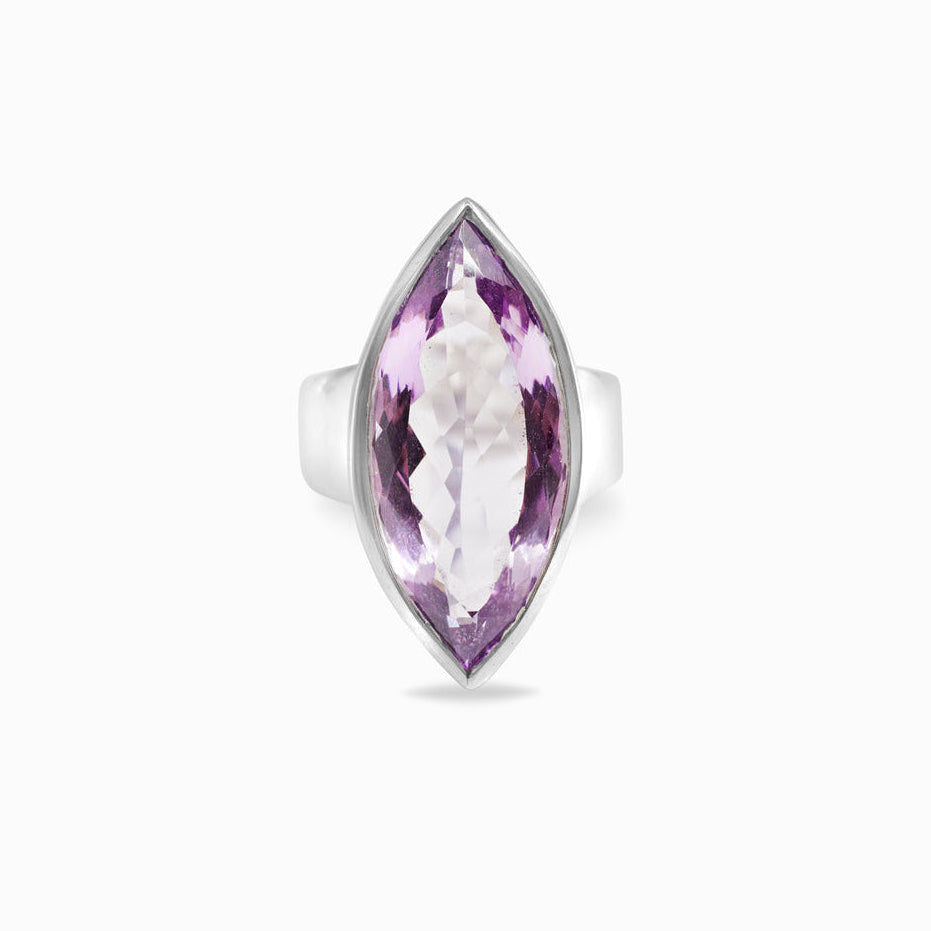 Silver ring with a marquise-shaped purple gemstone on a white background